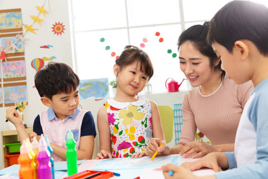 woman working with group of children